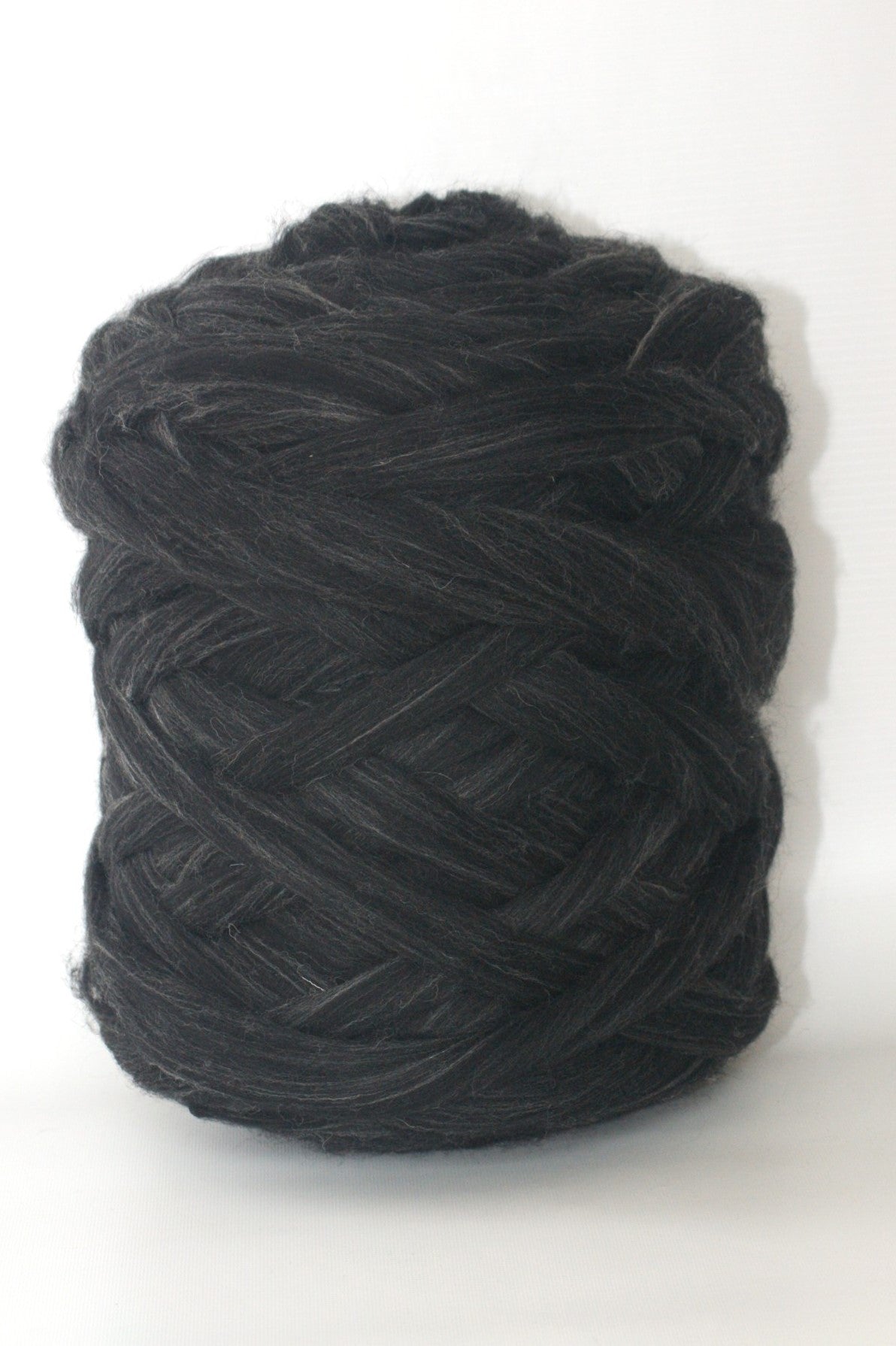 Ball of antracite wool yarn on a white background