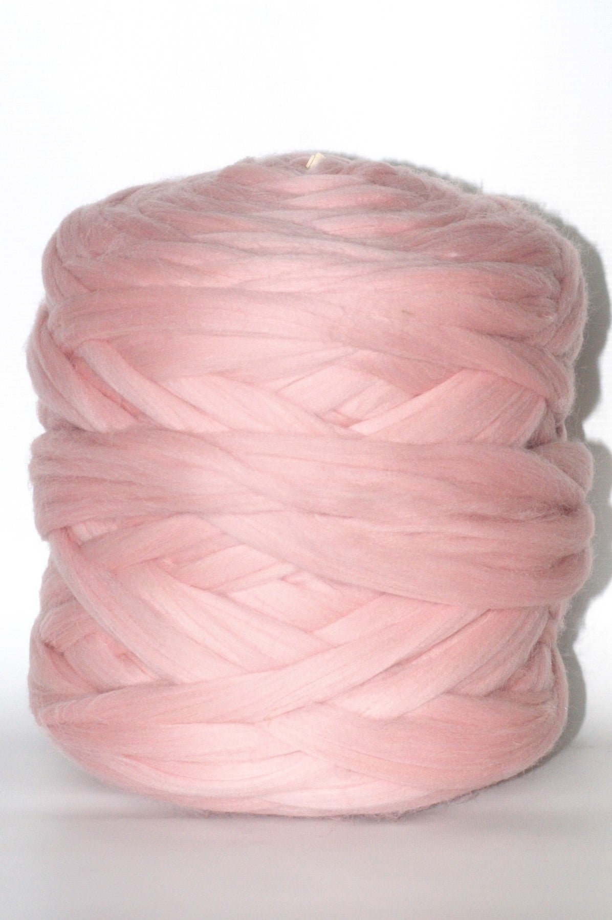 Baby pink chunky wool yarn ball on a white background