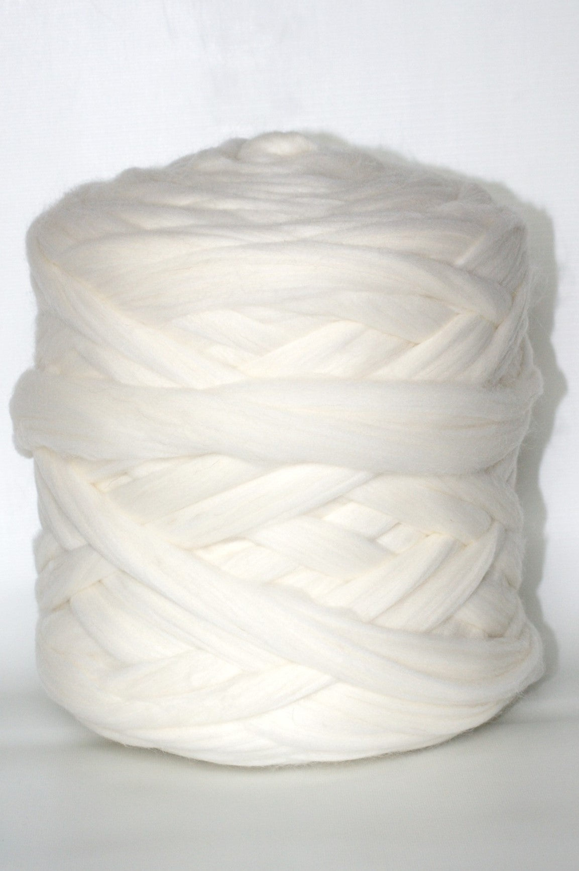 white colored chunky wool yarn ball on a white background