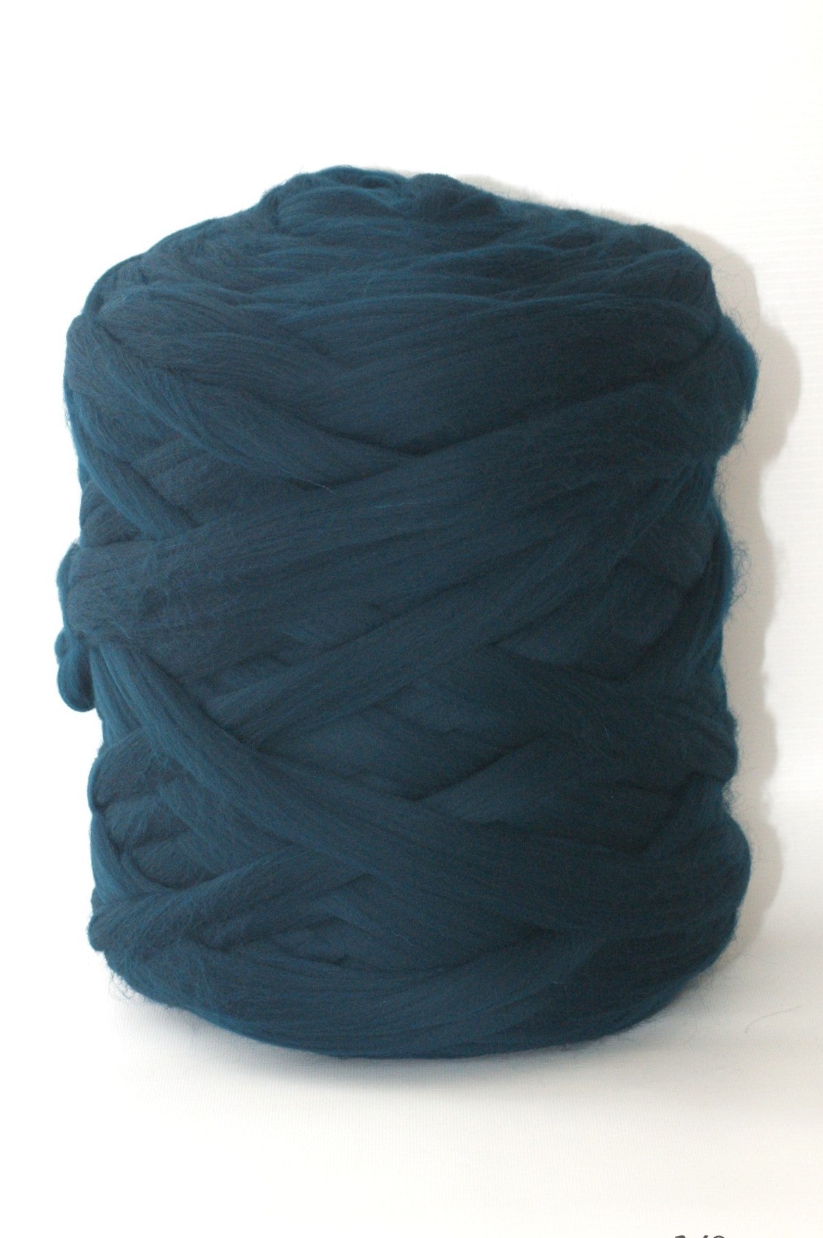 Sea green skein of chunky wool yarn on a white background