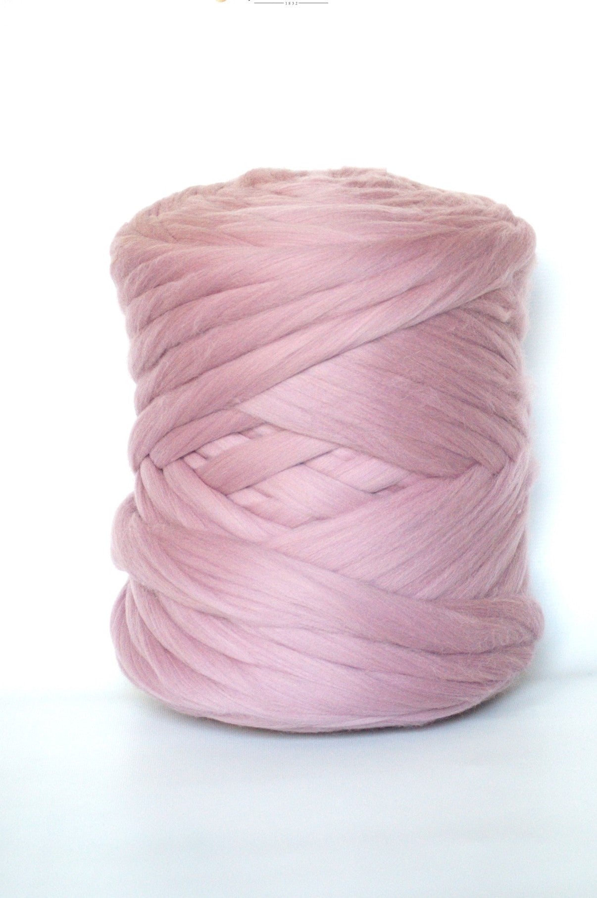 Dusty pink wool yarn ball on a white background