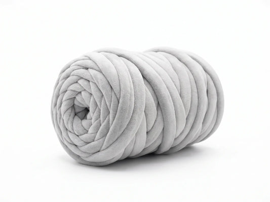 A light gray chunky velvet tube yarn ball, photographed on a seamless white background.