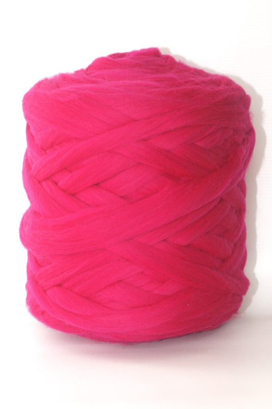 Ball of bright pink chunky wool yarn on a white background