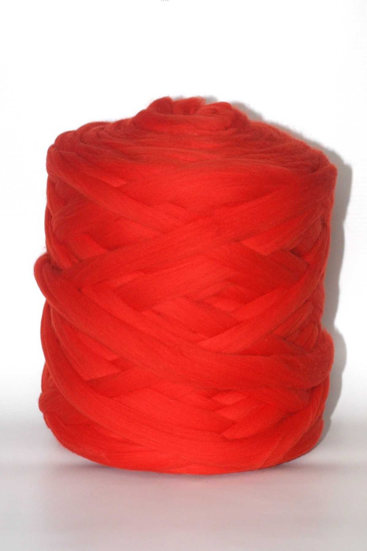 Red chunky yarn ball on a white background