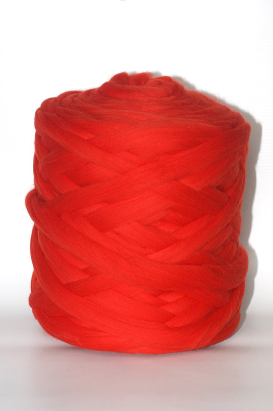 Red chunky yarn ball on a white background