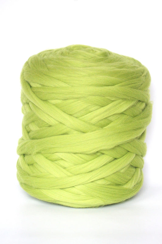 Apple green skein of chunky wool yarn on a white background