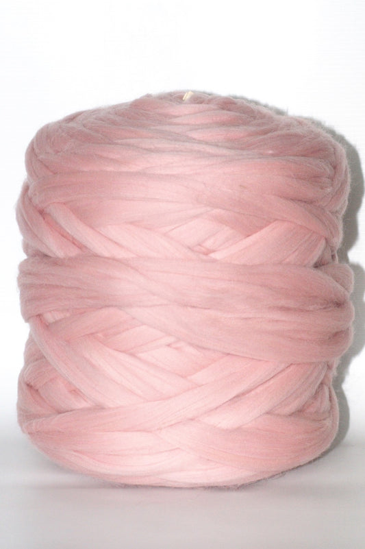 Baby pink chunky wool yarn ball on a white background