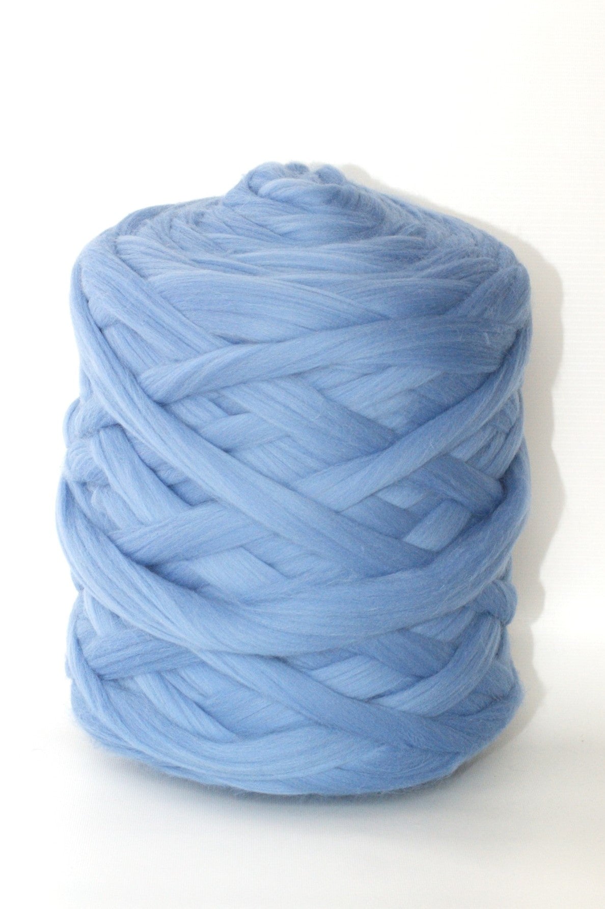 Baby blue  chunky wool yarn ball on a white background
