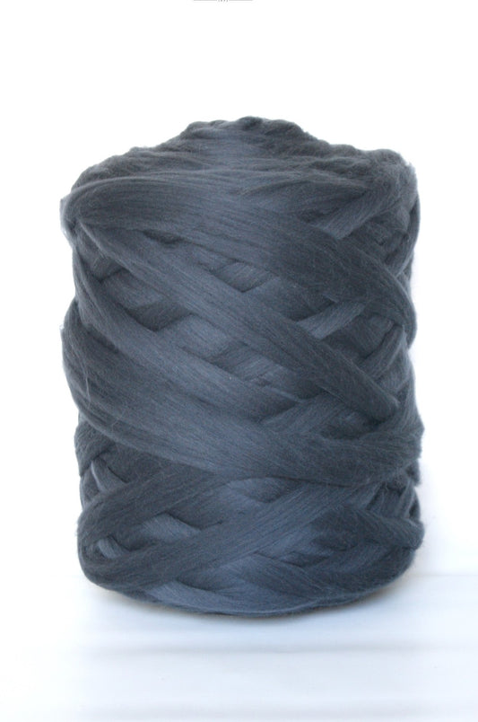 Ball of charcoal wool yarn on a white background