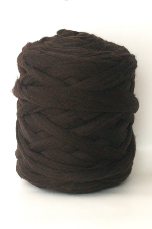 Ball of dark brown  chunky wool yarn on a white background