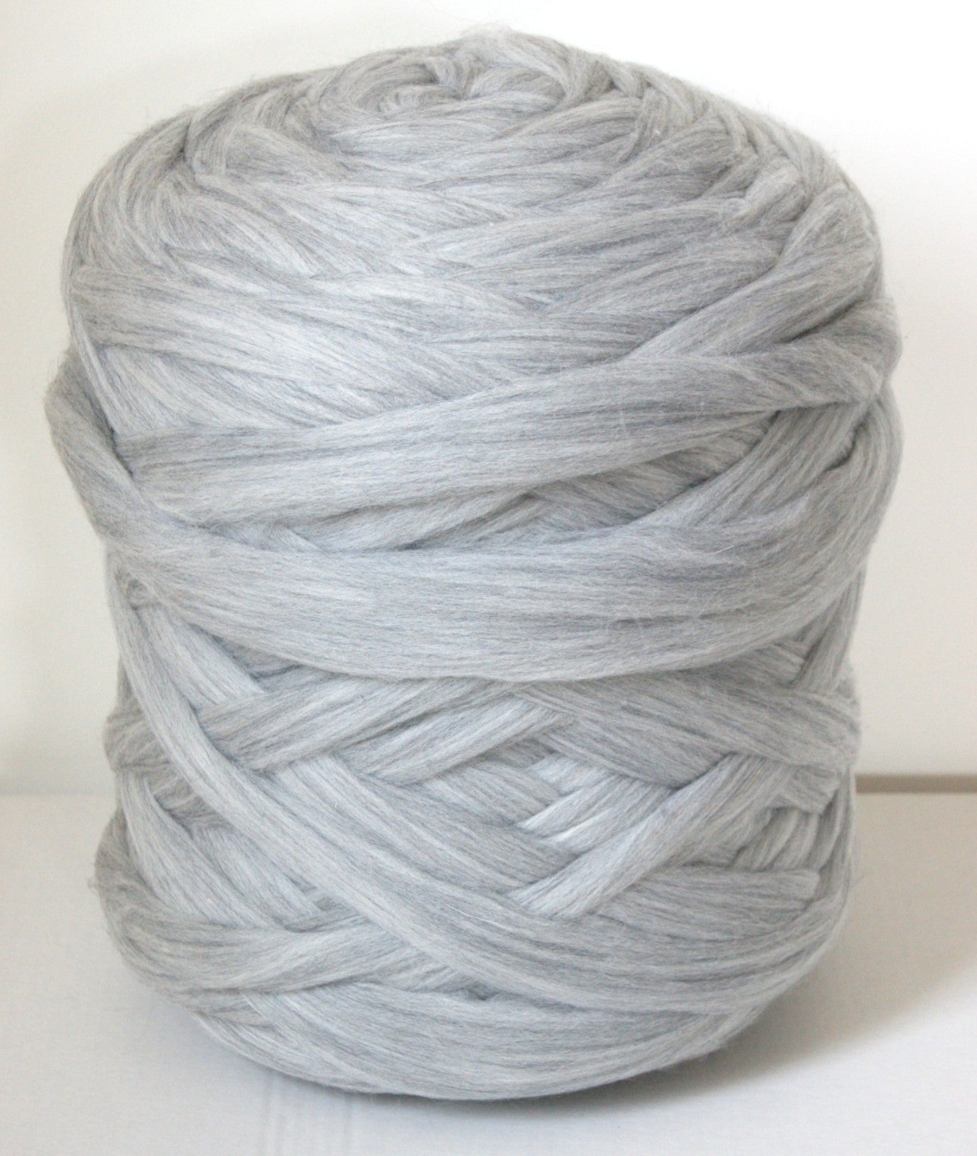Ball of chunky wool gray yarn on a white background