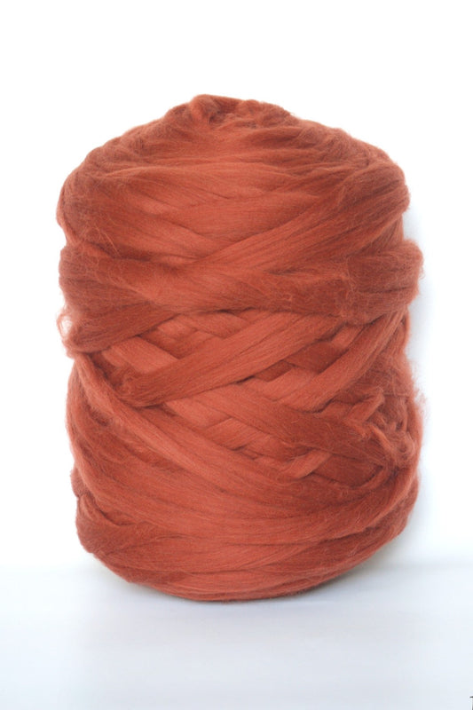 Ball of Copper chunky wool yarn on a white background