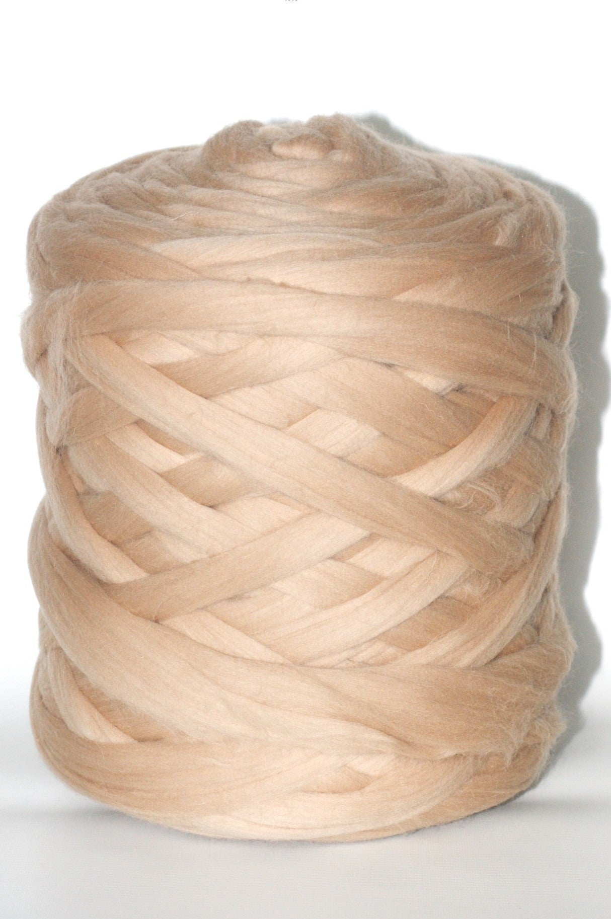Ball of dark beige chunky yarn on a white background