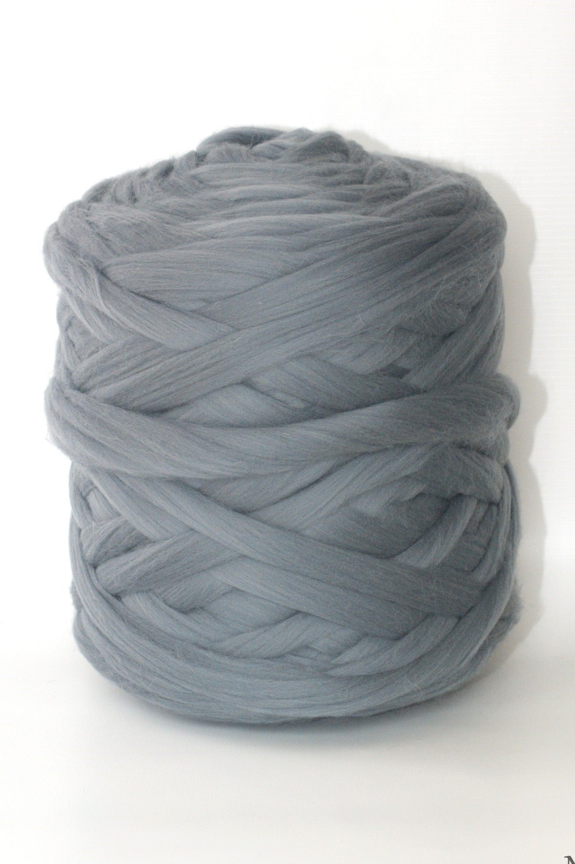 Ball of dark gray chunky wool yarn on a white background