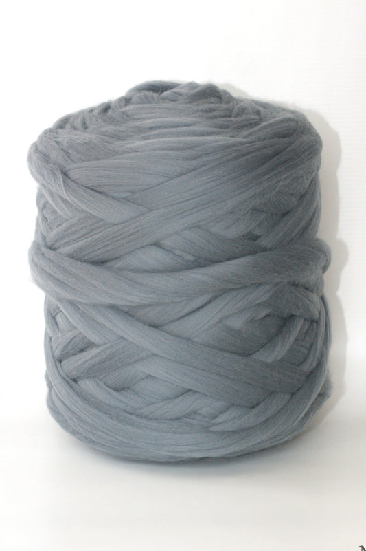 Ball of dark gray chunky wool yarn on a white background