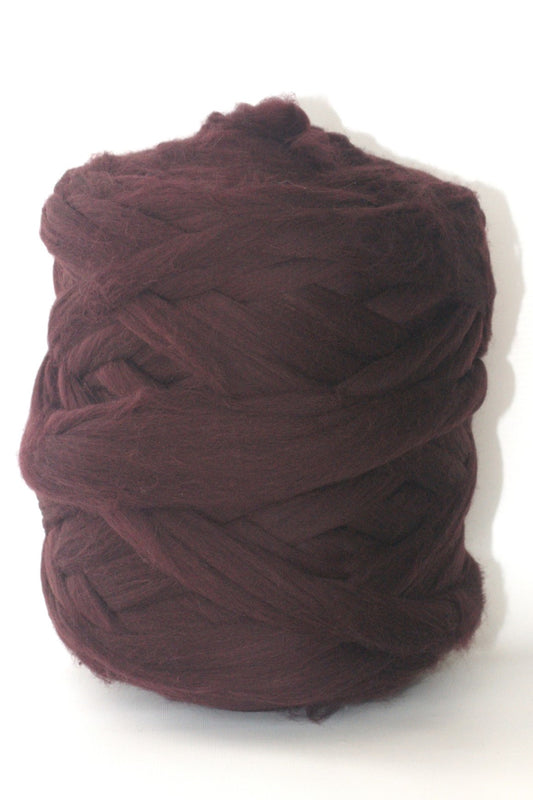 Ball of Eggplant chunky wool  yarn on a white background