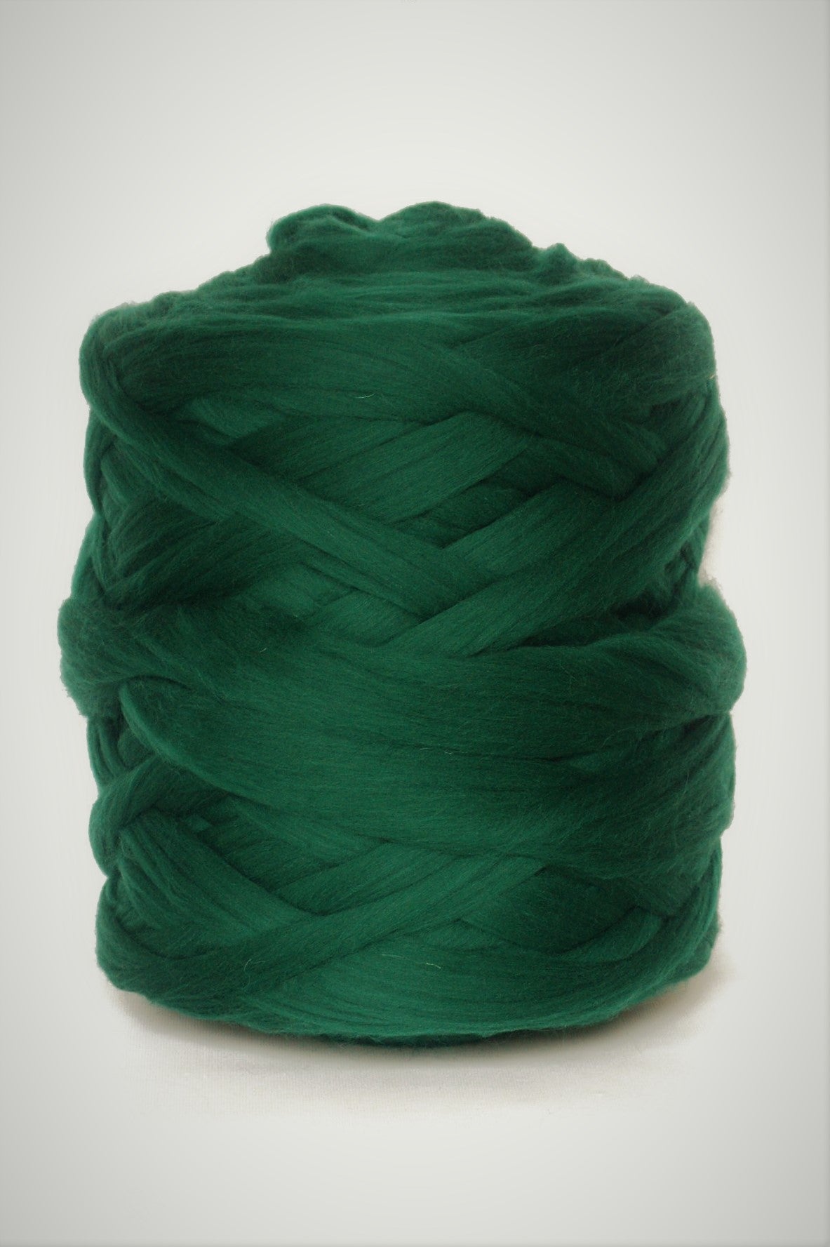 Emerald Green chunky wool yarn ball on a white background