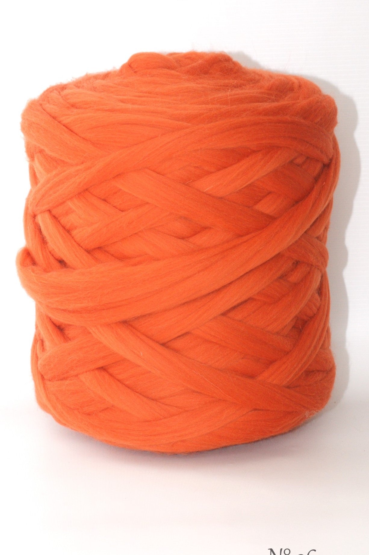 Foxy Orange wool yarn ball on a white background
