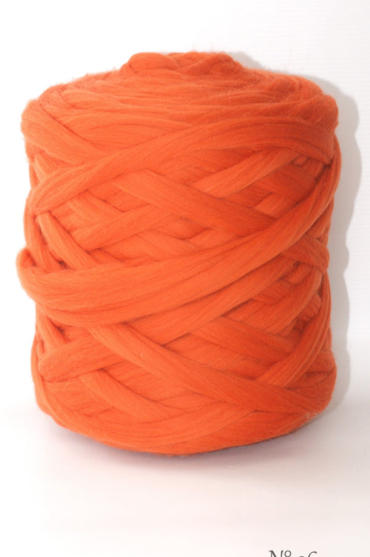 Foxy Orange wool yarn ball on a white background
