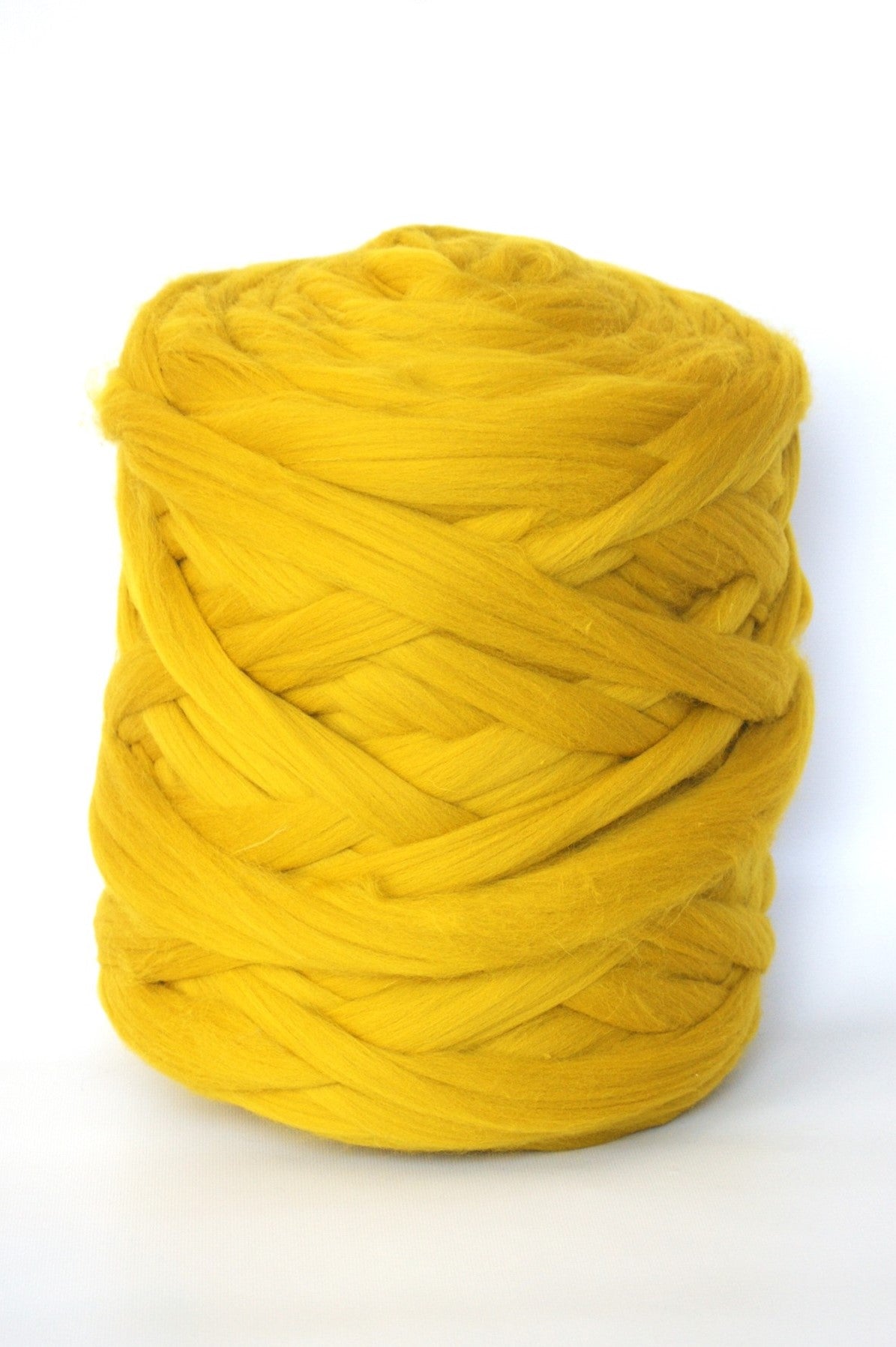 mustard chunky wool yarn ball on a white background