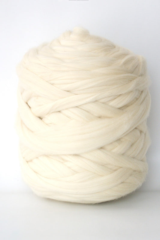 Cream-colored chunky wool yarn ball on a white background
