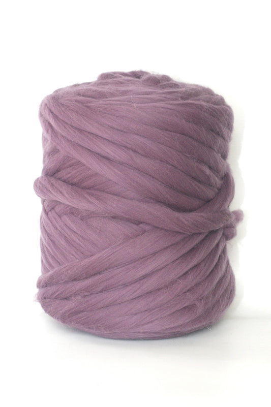 Ball of Pale purple wool yarn on a white background
