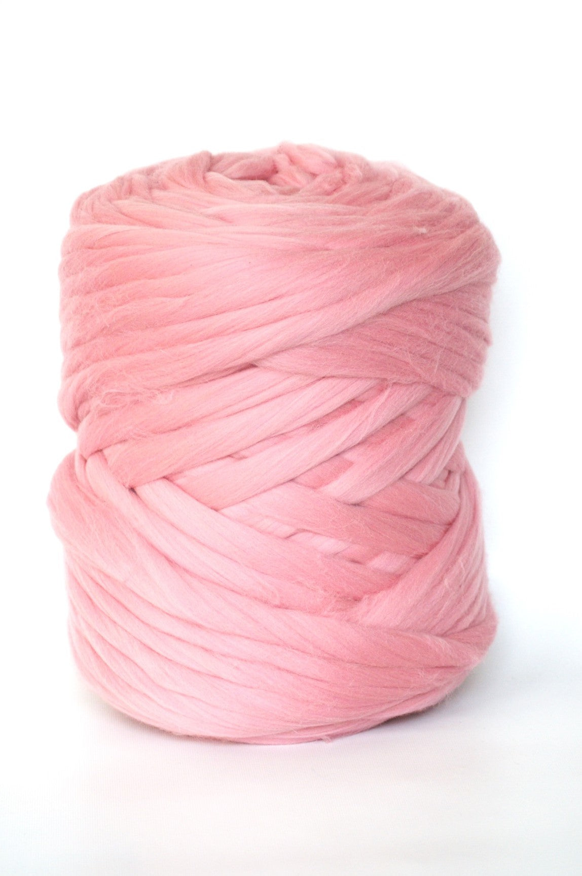 Powder pink chunky wool yarn ball on a white background