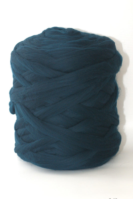 Sea green skein of chunky wool yarn on a white background
