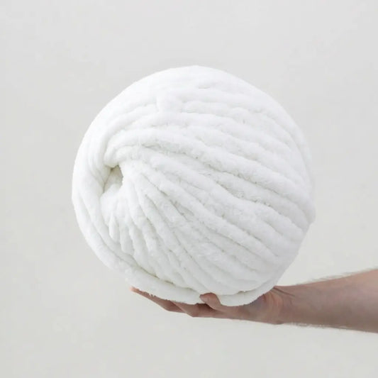 Man hold giant snow white color chenille yarn on white  background